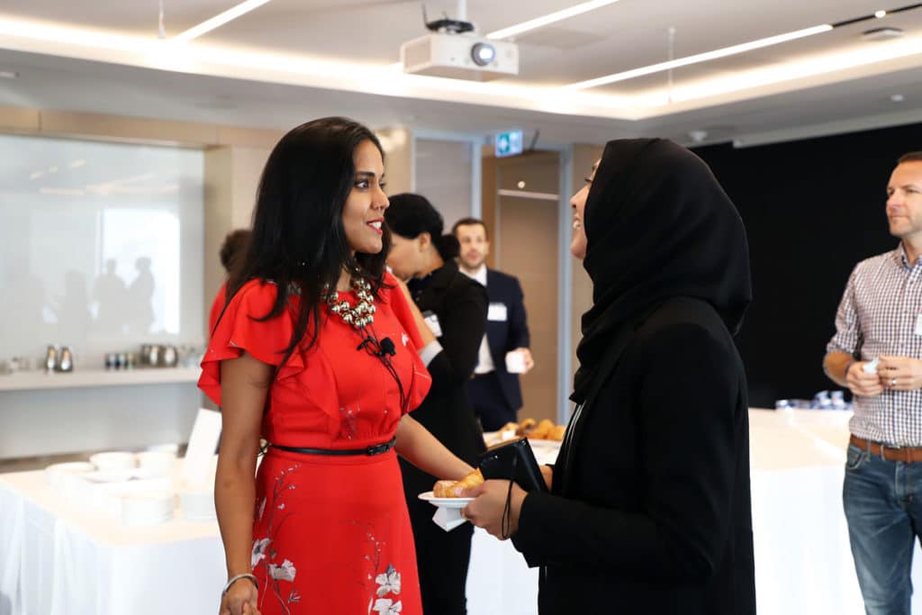 Ritu Bhasin speaking to a Muslim woman wearing a hijab