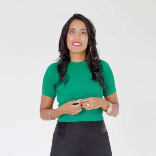 Ritu Bhasin wearing a bright green top and black bottoms.